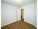 Bright bedroom with hardwood floors featuring access to additional rooms at 6017 Whitaker Ln, Raleigh, NC 27603