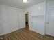 This bedroom features hardwood floors and built in cabinets with an adjacent doorway at 6017 Whitaker Ln, Raleigh, NC 27603