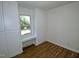 A bedroom featuring hardwood floors, built-in cabinets, and a window bench at 6017 Whitaker Ln, Raleigh, NC 27603