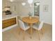 Inviting dining area adjacent to the kitchen, with a round wooden table and cozy seating for four at 6017 Whitaker Ln, Raleigh, NC 27603