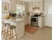 Updated kitchen with stainless steel appliances, light countertops and cabinets and modern fixtures at 6017 Whitaker Ln, Raleigh, NC 27603
