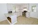 Kitchen with stainless steel appliances, light countertops and cabinets and modern fixtures and adjacent back door at 6017 Whitaker Ln, Raleigh, NC 27603