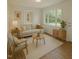 Bright living room with hardwood floors, neutral paint, and large windows offering natural light at 6017 Whitaker Ln, Raleigh, NC 27603