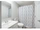 Cozy bathroom with tiled floors, a white vanity sink, and shower with stylish curtain at 603 Middleton Ave, Cary, NC 27513