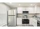 Modern kitchen with stainless steel appliances and white cabinets at 603 Middleton Ave, Cary, NC 27513