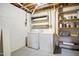 Basement laundry room featuring washer, dryer, shelving and unfinished walls at 603 Middleton Ave, Cary, NC 27513
