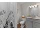 Well-lit bathroom with modern vanity, granite countertop, and stylish shower curtain at 605 Larchwood Dr, Durham, NC 27713