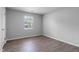 Empty bedroom offers natural light and wood-look floors at 605 Larchwood Dr, Durham, NC 27713