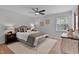 Well-lit bedroom offers a ceiling fan, neutral decor, and hardwood flooring at 605 Larchwood Dr, Durham, NC 27713