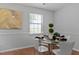 Eat-in kitchen with glass table, seating for four and modern art at 605 Larchwood Dr, Durham, NC 27713
