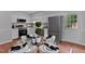 The kitchen features white cabinetry, stainless appliances, and a view from the eat-in table at 605 Larchwood Dr, Durham, NC 27713