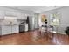 Bright eat-in kitchen features white cabinets, stainless steel appliances, and a window for natural light at 605 Larchwood Dr, Durham, NC 27713