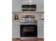 Stylish kitchen showcasing stainless steel oven, appliances, and white cabinetry creating a modern culinary space at 605 Larchwood Dr, Durham, NC 27713