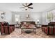 Comfortable living room featuring stylish furniture, a ceiling fan, and ample natural light at 605 Larchwood Dr, Durham, NC 27713