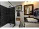 Unique bathroom featuring a dark tiled shower, decorative mirror, and stylish vanity at , Wake Forest, NC 27587