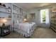 Comfortable bedroom with built-in shelving, bright window, and cozy decor at , Wake Forest, NC 27587