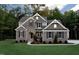 Beautiful two-story home with brick and stone exterior, complemented by a lush green lawn and mature trees at , Wake Forest, NC 27587