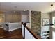 Open hallway with wood floors, brick fireplace, and natural light at , Wake Forest, NC 27587