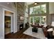 Cozy living room featuring a stone fireplace, soaring ceilings, and large windows offering natural light at , Wake Forest, NC 27587