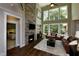 Cozy living room featuring a stone fireplace, soaring ceilings, and large windows offering natural light at , Wake Forest, NC 27587