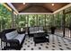 Inviting screened porch with comfortable wicker furniture and a beautiful view of the surrounding trees at , Wake Forest, NC 27587