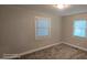 Bedroom with neutral walls, carpet and natural light offering a calm and inviting space at 626 Hoover Rd, Durham, NC 27703
