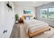 Stylishly decorated bedroom with a large window, modern furniture, and neutral color palette at 631 Southwick Pl, Mebane, NC 27302