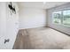 A blank canvas bedroom with a large window offering plenty of natural light and a neutral color palette at 631 Southwick Pl, Mebane, NC 27302