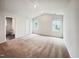 Spacious bedroom features two windows for natural light, neutral carpet, and access to the ensuite bathroom at 631 Southwick Pl, Mebane, NC 27302