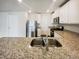 Open kitchen featuring granite countertops, a stainless steel sink, and modern appliances at 631 Southwick Pl, Mebane, NC 27302
