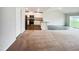 Expansive living space flowing into the kitchen with stainless steel appliances and ample lighting at 631 Southwick Pl, Mebane, NC 27302