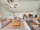 Spacious living room open to kitchen, with ceiling fan, stylish decor, and ample natural light at 631 Southwick Pl, Mebane, NC 27302