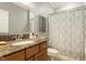 Bathroom featuring a granite countertop vanity, patterned shower curtain, and neutral color scheme at 7227 Cleveland Rd Rd, Clayton, NC 27520