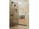 Shower featuring tiled walls, skylight, and glass door with an adjacent double vanity at 7227 Cleveland Rd Rd, Clayton, NC 27520