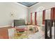 Sunlit Bedroom with a changing table, play gym, patterned rug, and an arched window with shutters at 7227 Cleveland Rd Rd, Clayton, NC 27520