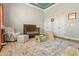 Bright Bedroom featuring a crib, armchair, and play area on a patterned rug with a blue ceiling at 7227 Cleveland Rd Rd, Clayton, NC 27520