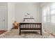 Bedroom featuring a wood-framed bed, desk, and patterned rug with natural light from the window at 7227 Cleveland Rd Rd, Clayton, NC 27520