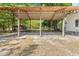 An outdoor carport with a gravel base and overhead cover provides ample parking and storage space at 7227 Cleveland Rd Rd, Clayton, NC 27520
