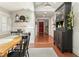 Cozy dining area with wooden table, wainscoting, and views to front door at 7227 Cleveland Rd Rd, Clayton, NC 27520