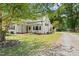 Charming white home with black shutters, a red front door and a well maintained lawn at 7227 Cleveland Rd Rd, Clayton, NC 27520