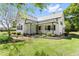 Charming white home with metal roof, landscaped yard, and inviting front porch at 7227 Cleveland Rd Rd, Clayton, NC 27520