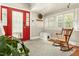 Sunlit foyer with rocking chair and view of front door at 7227 Cleveland Rd Rd, Clayton, NC 27520