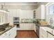 Well-lit kitchen with white cabinets, stainless appliances, and granite countertops at 7227 Cleveland Rd Rd, Clayton, NC 27520