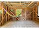 Relaxing shed featuring a hammock, wooden walls, patterned rug, and natural light, creating a peaceful retreat in nature at 7227 Cleveland Rd Rd, Clayton, NC 27520