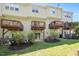 Townhome backyard with wooden decks, sliding glass doors, lush lawn and garden at 7616 Satinwing Ln, Raleigh, NC 27617