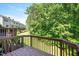 Relaxing outdoor space offers lush greenery and a wooden deck perfect for quiet enjoyment and entertaining at 7616 Satinwing Ln, Raleigh, NC 27617