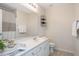 Well-lit bathroom features white cabinetry, a large mirror, and decorative accents that add a touch of elegance at 7616 Satinwing Ln, Raleigh, NC 27617