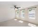 Inviting bedroom with three large windows offering ample natural light and picturesque views of the outdoors at 7616 Satinwing Ln, Raleigh, NC 27617