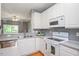 Functional kitchen with white cabinetry, efficient appliances, and ample counter space at 7616 Satinwing Ln, Raleigh, NC 27617