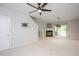 Open living area boasts a fireplace, contemporary lighting, and seamless transition to stairs for easy access at 7616 Satinwing Ln, Raleigh, NC 27617